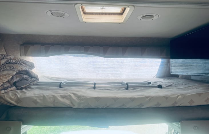 Above the cab bed With large living room TV.