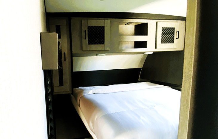 Cozy private bedroom with queen bed — perfect for a couple’s retreat to El Mirage, Alabama Hills, or Joshua Tree. Our RV rentals in Southern California include comfort-first travel trailers like this!