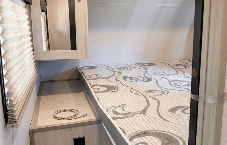 Comfortable Queen Size Bed with sliding doors for privacy.