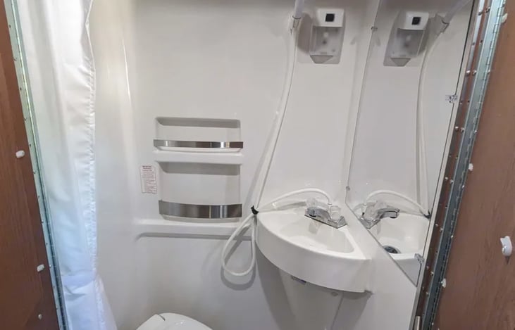 Wet Bath- You can shower standing up (about 6ft of headroom) or sitting on the toilet. Drain on the floor. I also have an outdoor shower tent