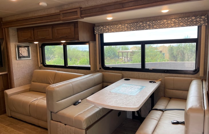 Main sitting area. Couch folds into a bed. Table can be lowered and cushions placed over for additional sleeping options. All windows open for fresh air.
