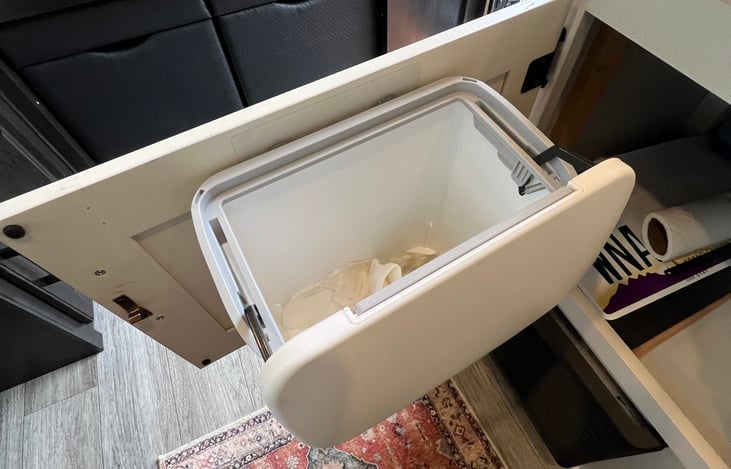 Compact garbage can with bags provided