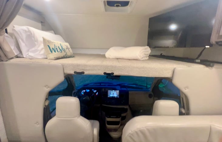 King bed overtop bunk.  TV swivels out and includes DVD player with some movies in the cabinet included.