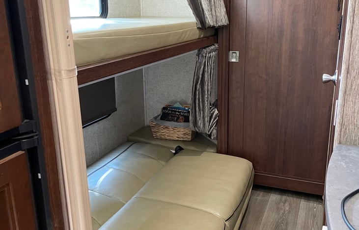 Bottom bunk turns into larger bed (about full size).