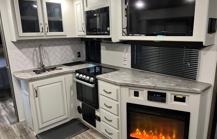 Kitchen area with fireplace and t.v.