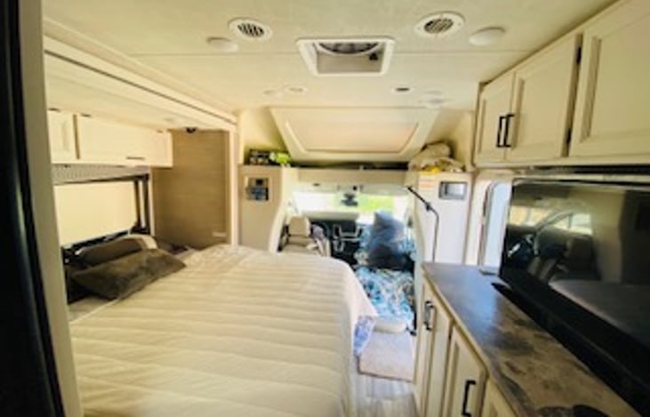 This RV has a murphy bed, which pulls down from the wall and covers the sitting sofa. This is a queen sized bed with a mattress pad to add softness to the already comfortable bed.