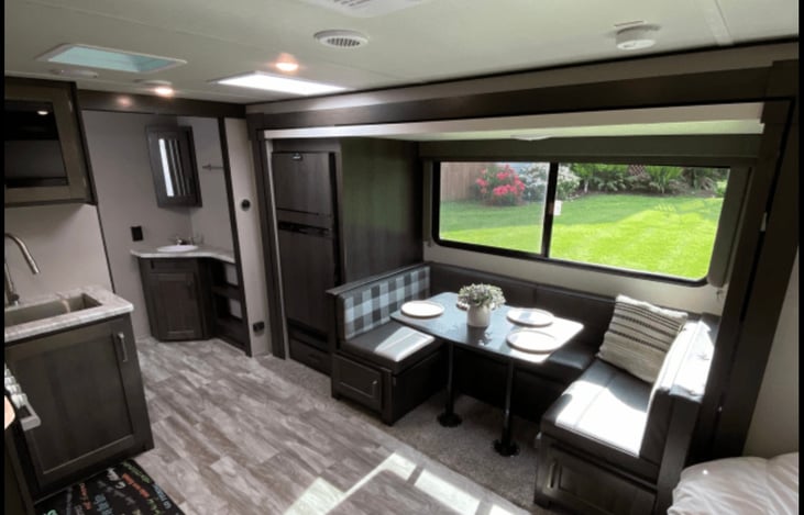 Dinette table easily seats 4-5 people. We also include seating/table covers for outdoor patio tables that are at camp sites. Plates, utensils, pots/pans. We have a fully stocked kitchen.