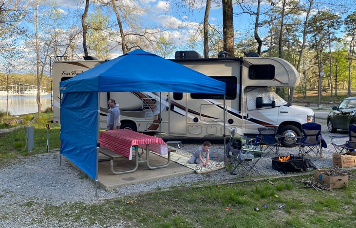 Enjoy the great outdoors with shelter and convenience, including four chairs and pop-up shade with rain/wind break.