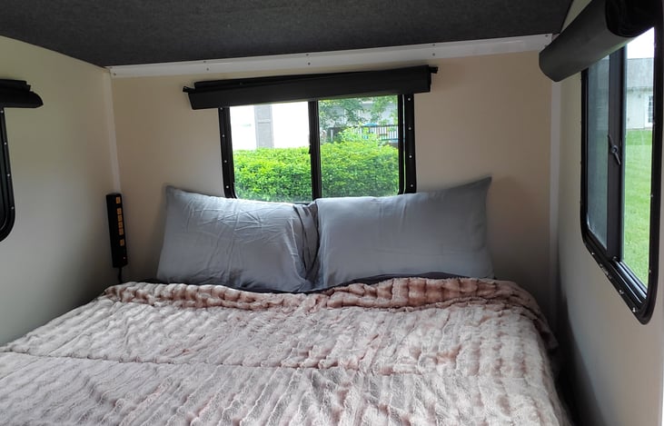 This comfy 8" thick memory foam mattress will give you a great night sleep. Convenient power-strip for charging phone located at the back of the camper.