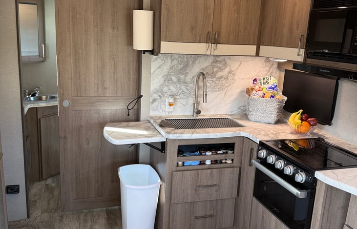 Off the kitchen is the bathroom with a sliding barn door. There is a second door between the bedroom and the bathroom. This is what makes this a great floorpan.