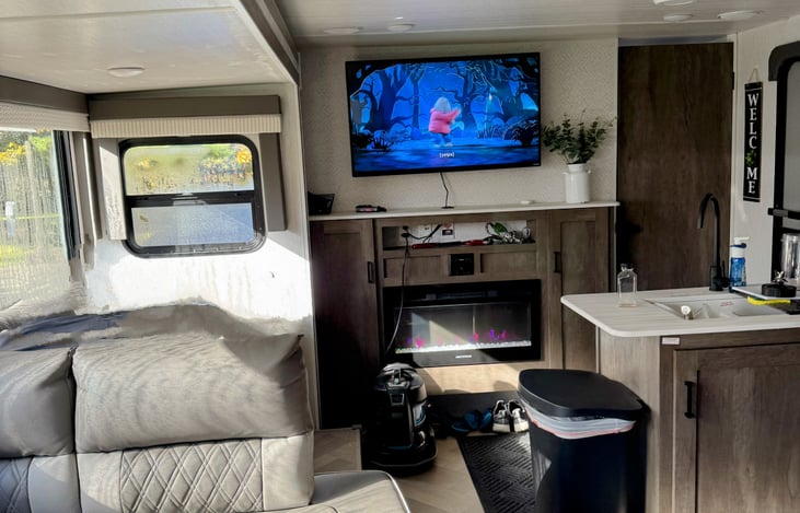 Here's a glimpse of our home away from home in action. Enjoying food and watching TV before starting our day. Living area with electric fireplace. Master bedroom is just through the door on the right.