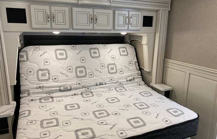 RV king size bed usb charging stations on each side as well as 120v outlets and reading lights.