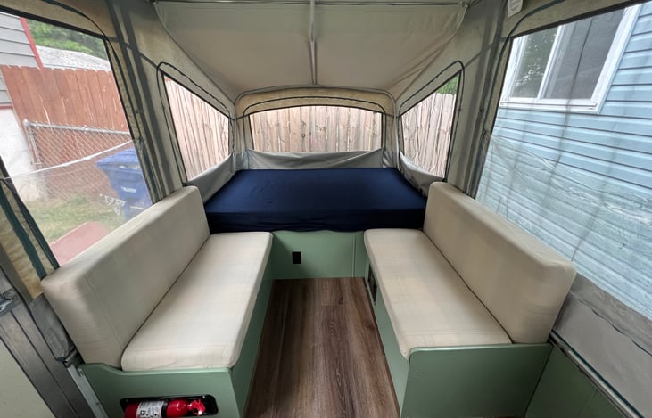 The dinette table can come out completely for a larger seating area. It can also be stowed to use as an extra bed.