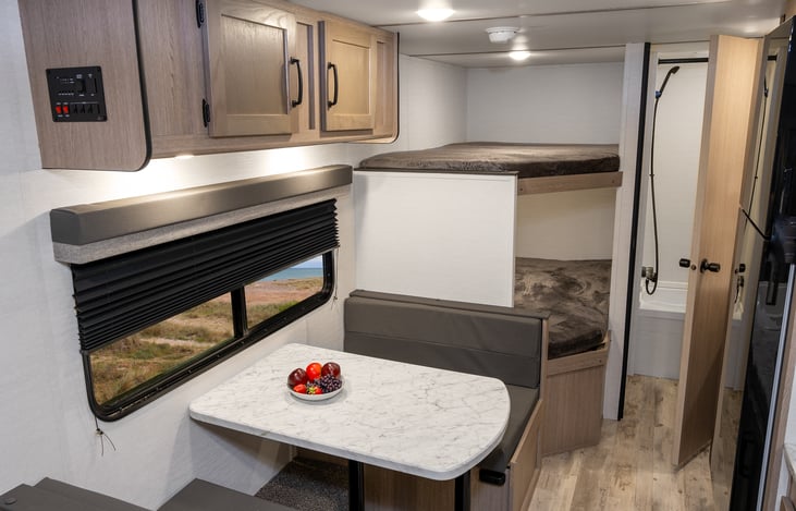 Rear table seat has extra blankets below and table collapses for extra sleeping space.