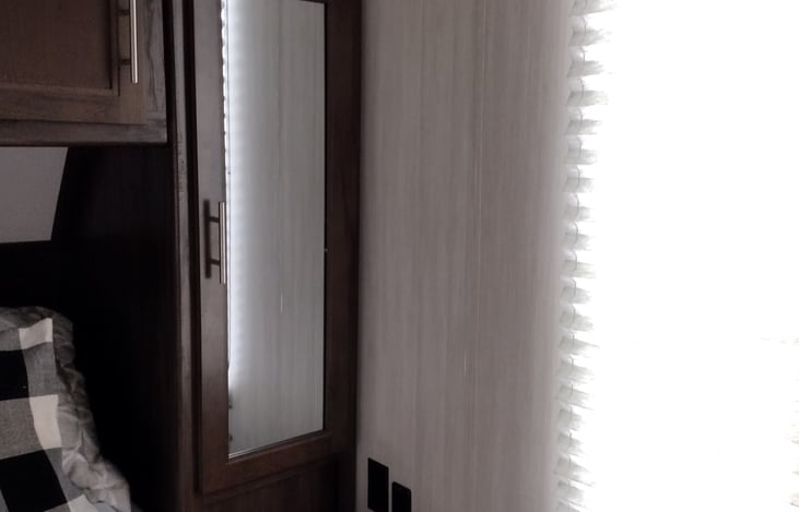 Side closet on each side of walk around bed and 2 windows in bedroom with overhead lighting over the bed for reading.