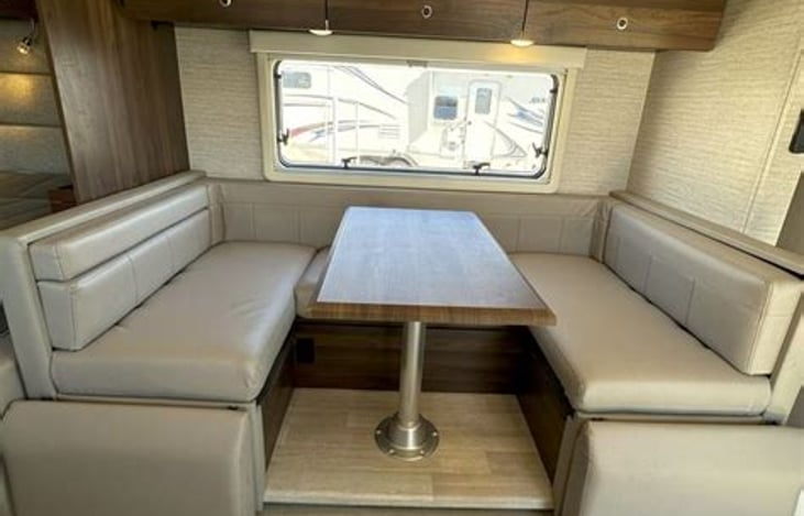 This dinette converts to a bed. The third bed is a loft above the driver and passenger seat at the front of the RV. (The first bed is the fold-down Murphy bed)