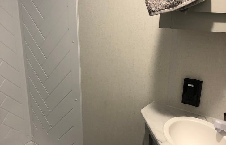 Very functional bathroom with stand up shower. Vanity with towels for four