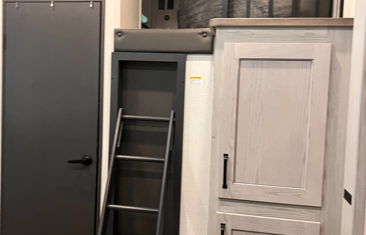 Pullout stairs to loft, and pantry cabinet on the right.