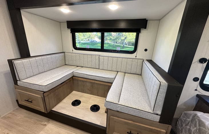 Dinette seating area shown in lounge mode with storage drawers below.