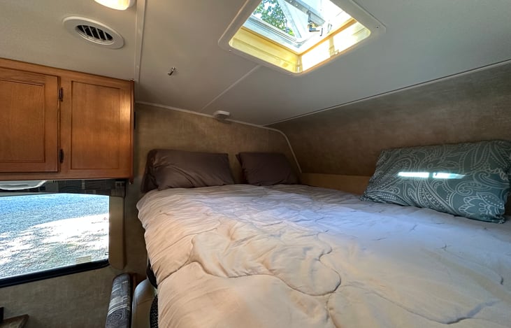 Over cab bed is a huge space 8 ft by 6 ft space. outlets for phone charging and reading lights make a cozy spot.