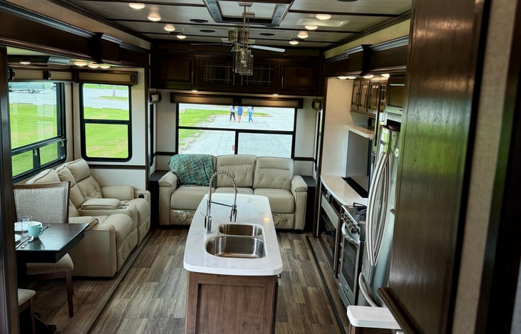 Welcome to Luxury: Massive 100-inch wide-body rear living area with cathedral 7-foot ceiling heights and dual opposing slide-outs.