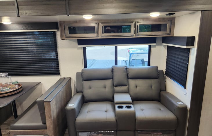 reclining chairs with vibration, heater and USB ports.  Also cup holders and center console.  Chairs recline to sleep on