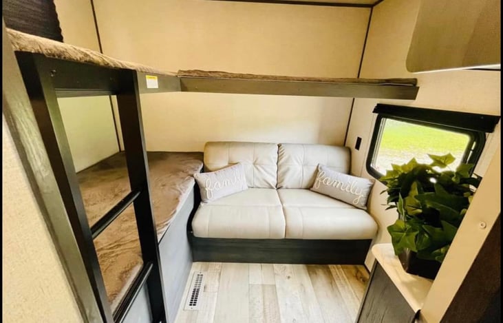 This is the bunkhouse. There is a pocket door that separates this room from the rest of the camper. Extra sleeping bags, pillows, and games are stored here for you to use.