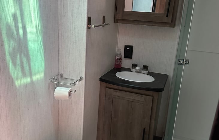 Bathroom has Sink and Shower. 4 Bath Towels, 2 Hand Towels, and Toilet Paper is Provided in Rental.