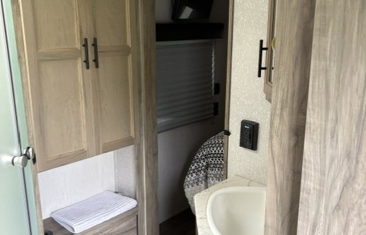 View of bathroom from the hallway near entry door. Also has sliding entry door into bedroom. Two entrances into bathroom.