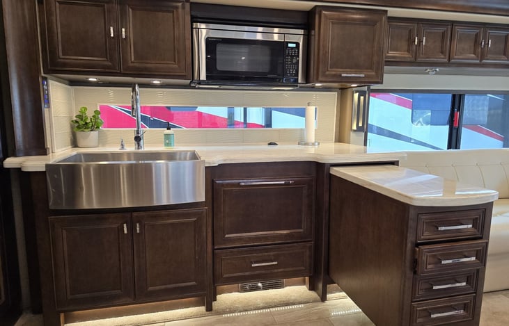 Kitchen has a pull out island for extra counter space.  The drawers in the island are as long as the island!  Drawers are filled with silverware and knives, cooking utensils, hot mitts and dish cloths