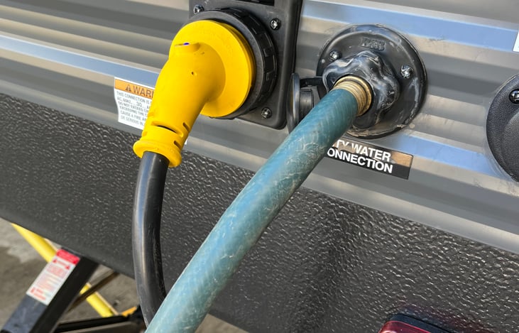 Fresh water connection and 30 amp power inlet. Can be plugged into 50 amp service as well.