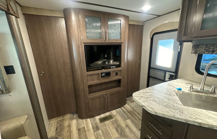 Master bedroom with privacy door closed. Tv can swivel from living room to bedroom.