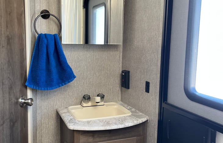 Bathroom sink and access door to outside.