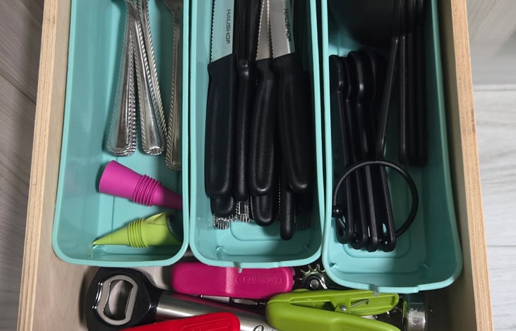 Forks, spoons, butter and steak knives, measuring spoons, chip clips, wine bottle and beer bottle opener, bottle stoppers