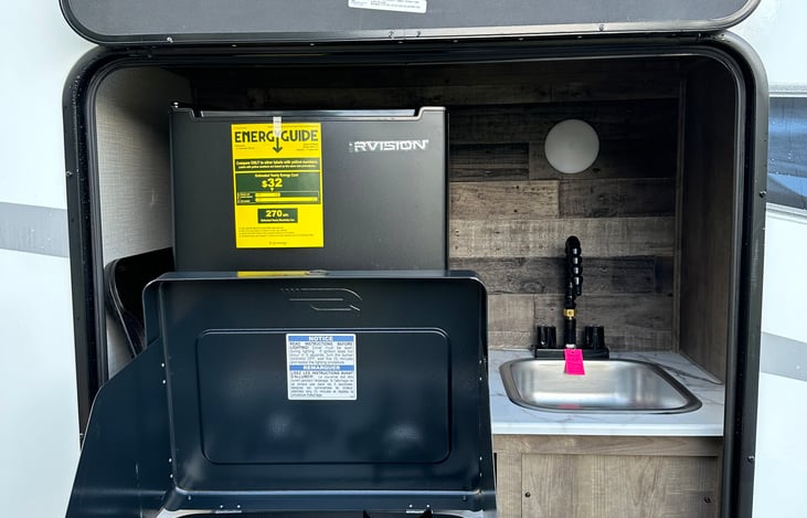 Campfire cafe with mini fridge, pullout cooktop, and sink