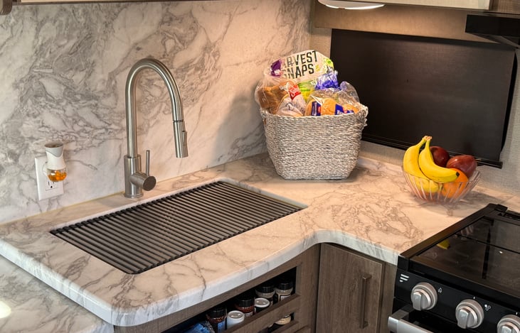 Plenty of room on the counter for snacks. There are also many cabinets with baskets for all your dry goods.
