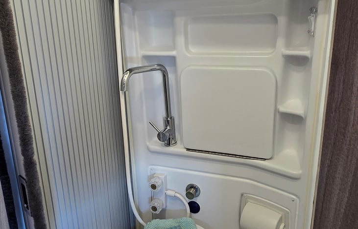 Bathroom with swivel toilet.