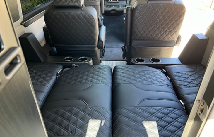 Rear bench seats that convert to a small bed. (Nearly a RV Full Bed @ Approx 48″X70″)