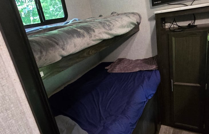Double bunk on bottom , single on top.