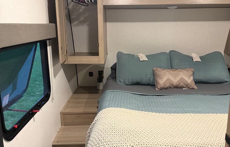 Master bed and closet with hangers