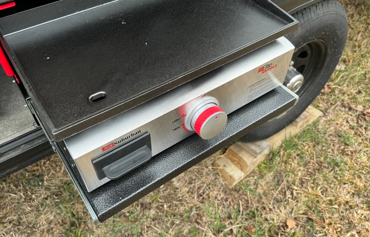 outside  cook station with griddle and mini fridge