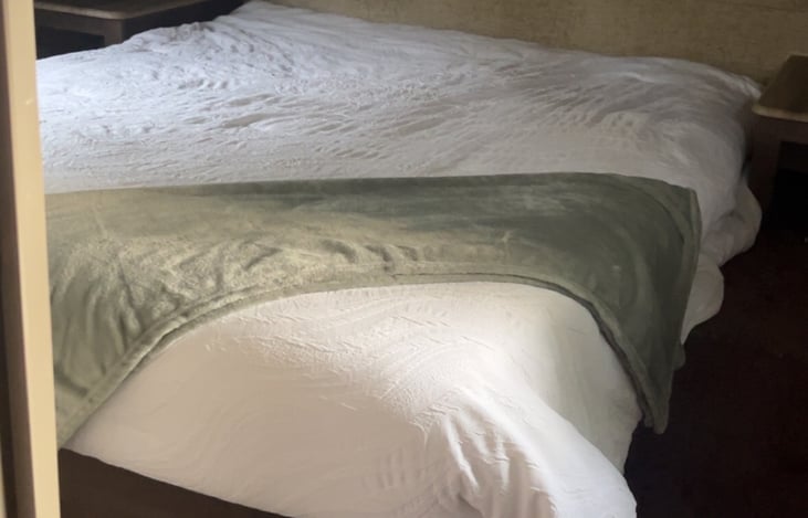 Queen size bed. Two closet spaces on each side of bed.