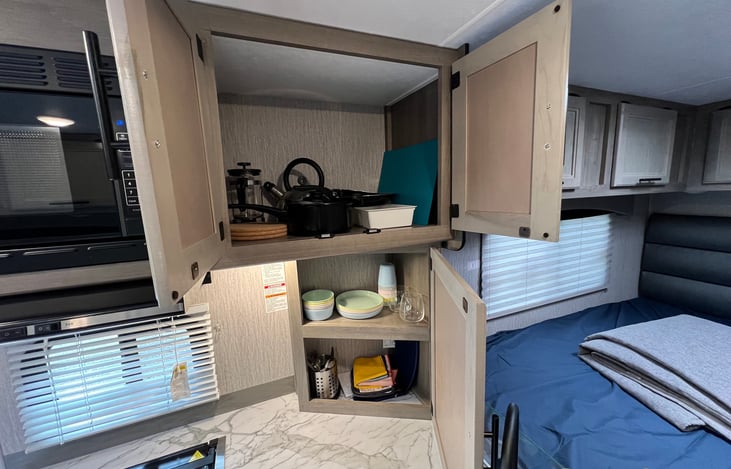 Kitchen is stocked with essential utensils.