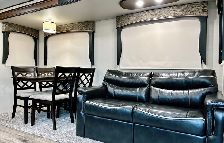 Dinette for 4 with a leather couch that makes out into a full bed.