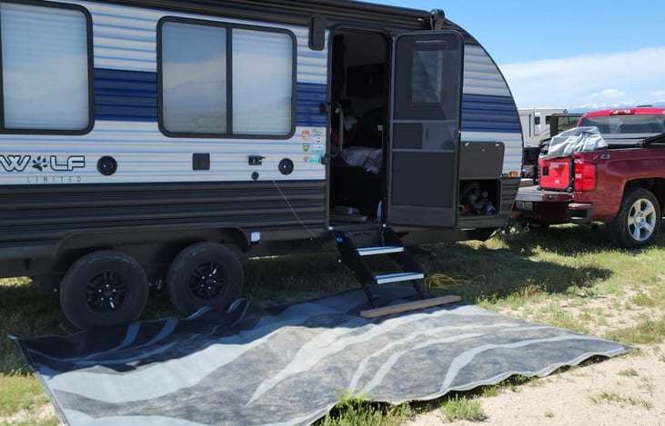 Camping in a pasture on a ranch in Wyoming.
awning up due to high winds.  LED light up rug available if requested.