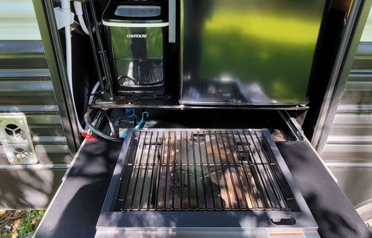 Closeup of gas grill. There's now an LCD lamp in here, too, for light where you need it.