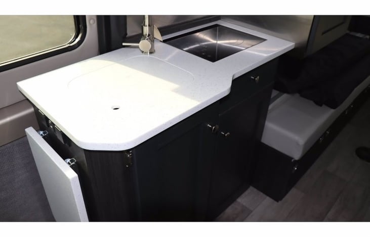 Kitchen
LUNA's kitchen offers a 1 burner convection stove, sink, microwave and extending countertop for extra prep space