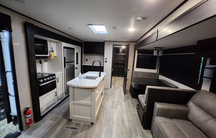 Living area sofa pulls out to bed.
kitchen area has gas stove, microwave, pantry and full refrigerator and dinette area.