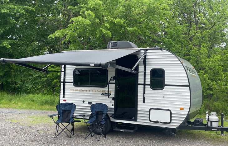 Under the awning there is an outdoor recepticle, USB/Bluetooth speakers and LED lighting. The folding chairs travel with the trailer.