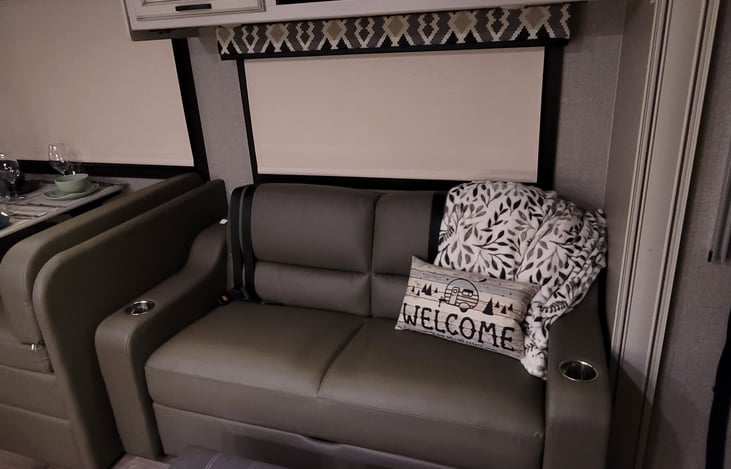 Sofa in Living area converts into full-size base with inflatable mattress.  Seat belts in sofa. Pantry above, along with extra linens to setup the pull-out inflatable bed.
